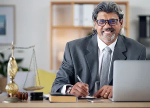 Why Hiring a Mesothelioma Lawyer Early Matters 1 Experienced lawyer smiling while reviewing documents in a professional office setting.