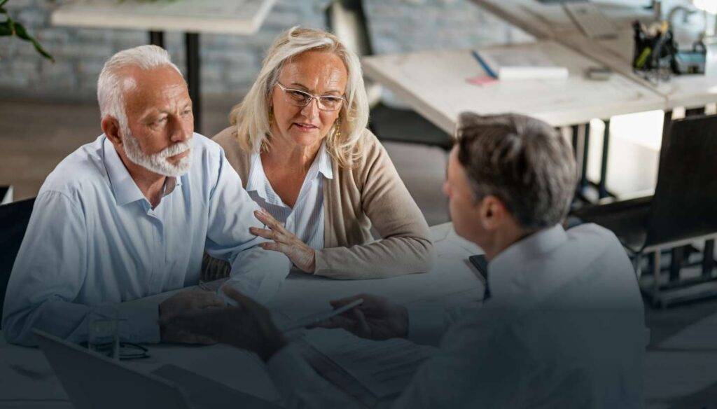 Couple talking to a lawyer during a legal consultation.