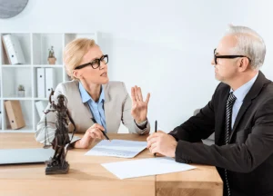 photo of a lawyer consulting with clients in an office.