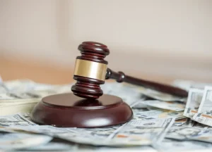 Gavel and cash representing large asbestos settlements in the U.S.