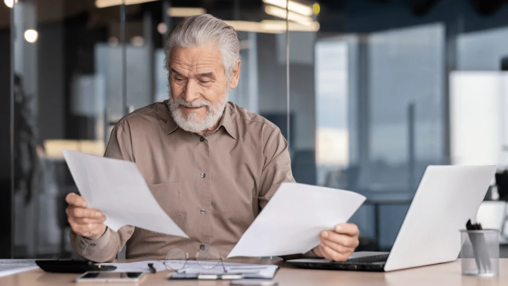Retired Texas veteran reviewing legal documents about mesothelioma compensation