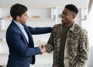 Military veteran shaking hands with a lawyer in an office, discussing mesothelioma legal options
