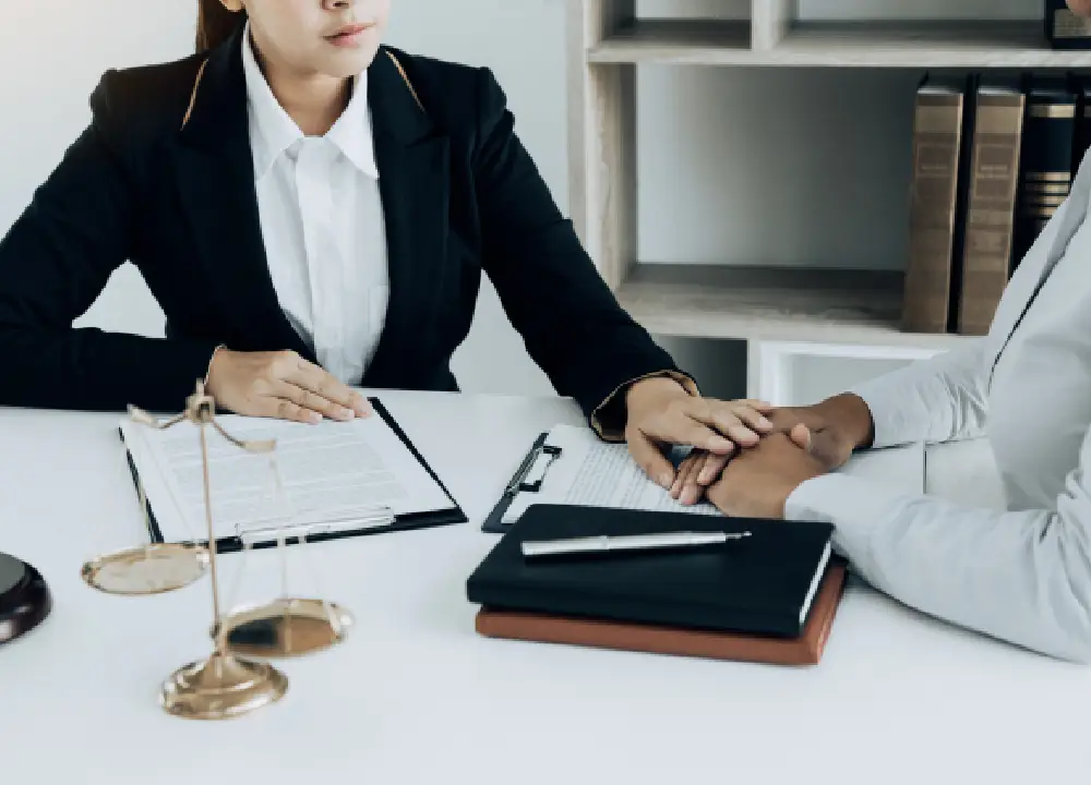 A specialized mesothelioma lawyer providing legal guidance to a client during a consultation in a professional office.