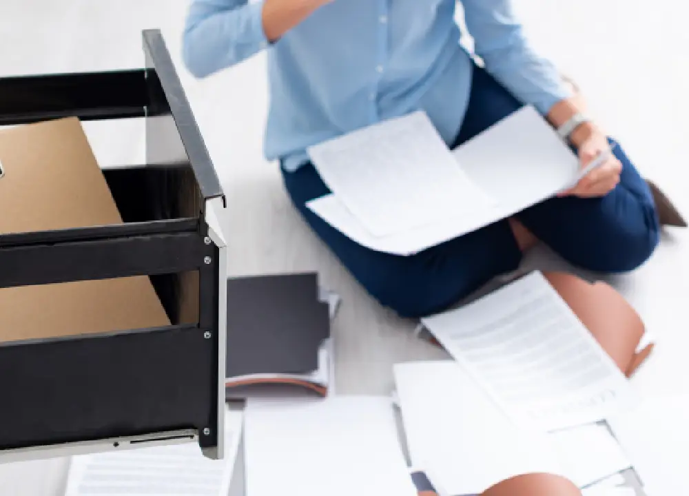 Person gathering and organizing documents as evidence for a legal claim.