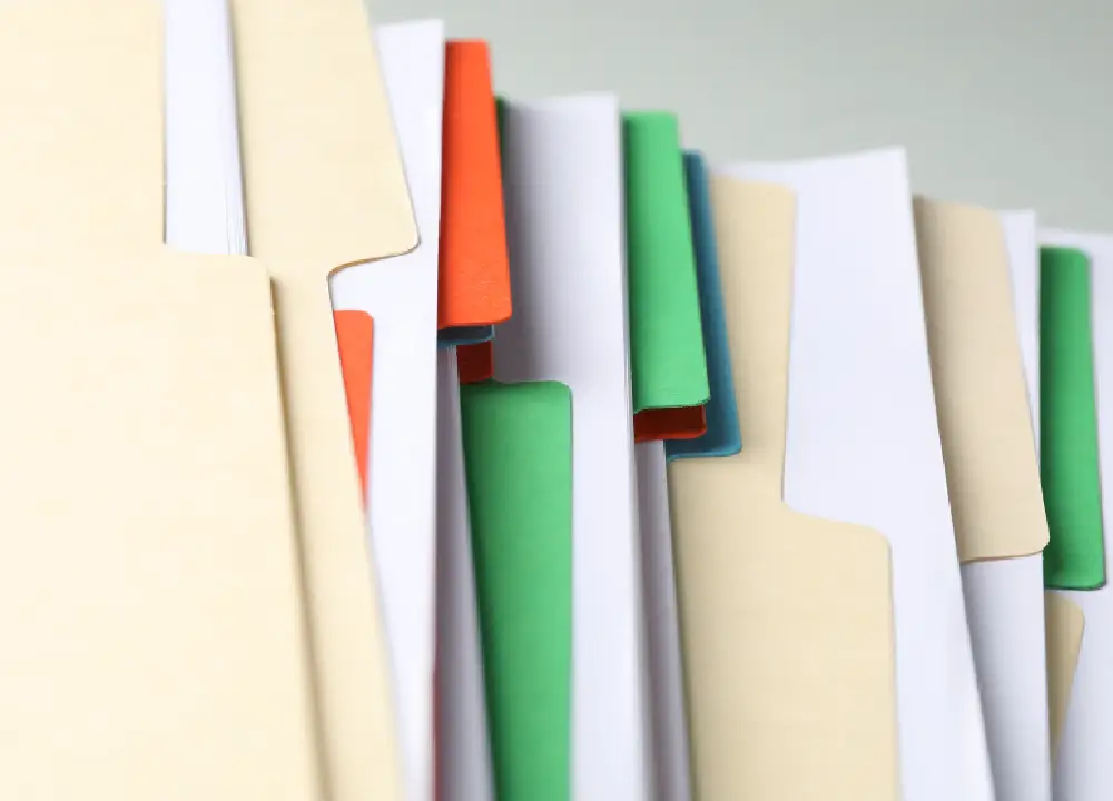 Understanding Mesothelioma Settlements: Your Path to Compensation 2 Close-up of organized legal folders and paperwork related to asbestos trust fund claims