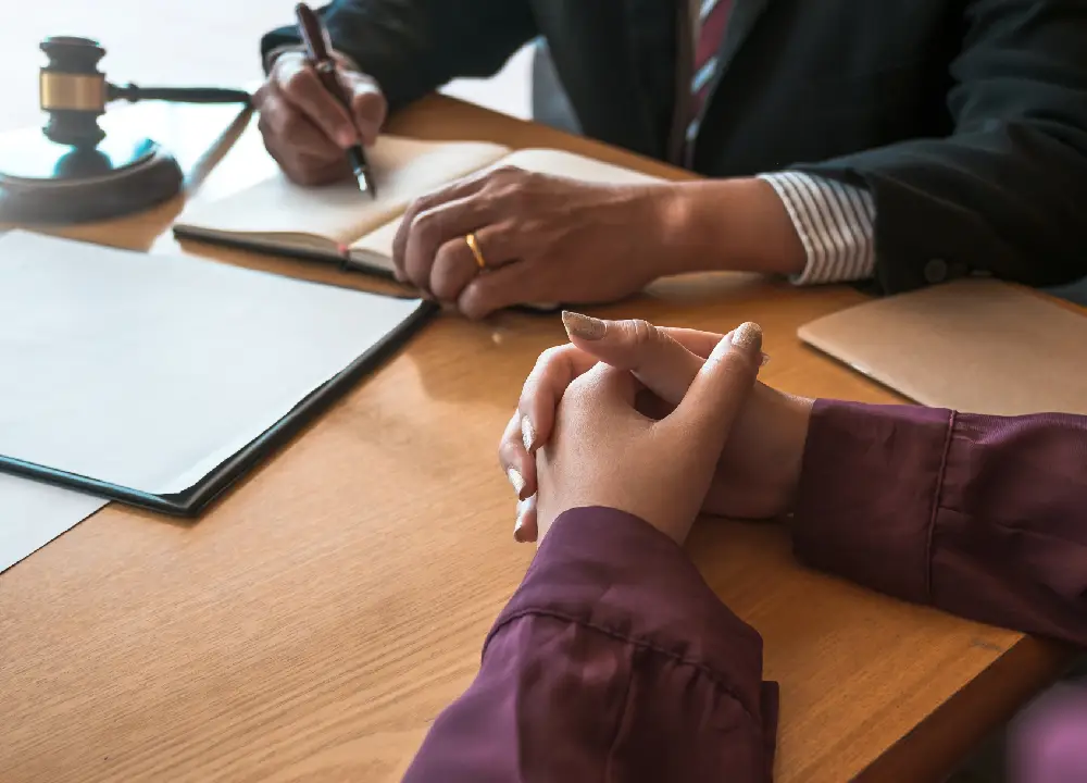 Mesothelioma Settlements vs. Lawsuits vs. Trust Funds 1 Client meeting with a lawyer reviewing documents during a legal consultation.