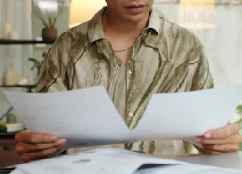 Mesothelioma Explained: Path to Justice and Compensation 1 Hands comparing legal paperwork on a desk.