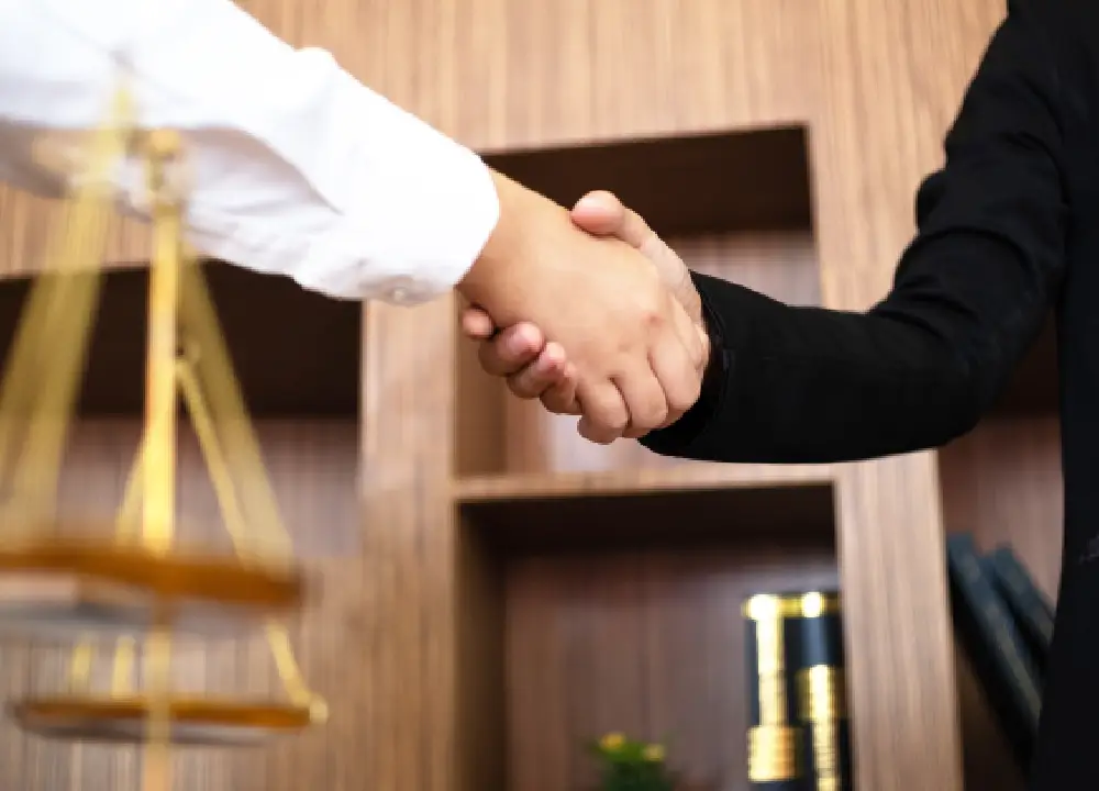 A Complete Guide to Mesothelioma Cancer: From First Symptoms to Legal Rights 3 Close-up of a professional handshake between a lawyer and a client symbolizing trust and partnership.