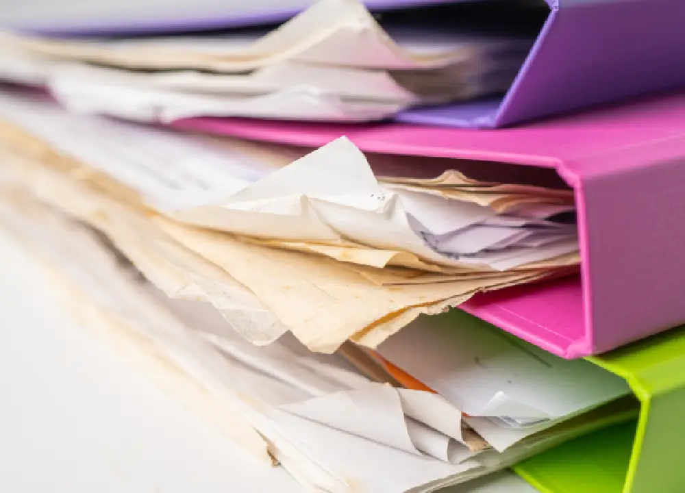 Navigating Compensation Claims for Occupational Talc Exposure 3 A close-up of organized medical records and employment history documents in a folder on a desk.