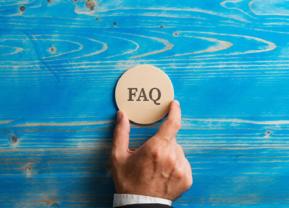 Navigating Mesothelioma Cancer: Essential Info and Support 3 Hand holding a wooden circle with an FAQ sign on it.