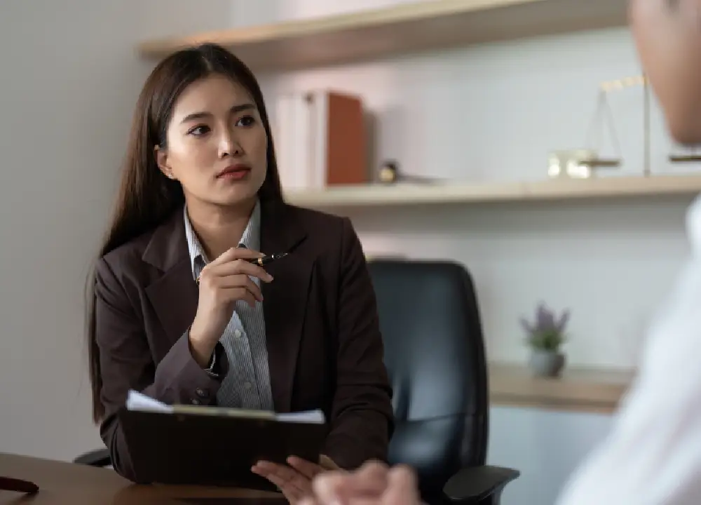 The Connection Between Talc and Asbestos: Protect Your Health 3 Lawyer consulting with a client in a friendly and professional office setting.