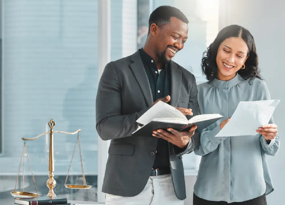 Maximizing Compensation through Asbestos Trust Funds 3 Legal professionals reviewing information together in a supportive consultation