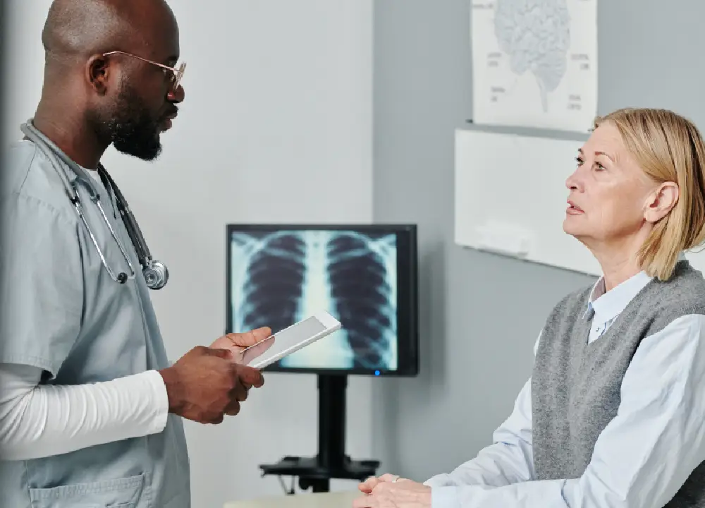 Navigating Compensation Claims for Occupational Talc Exposure 2 A doctor and patient reviewing a chest X-ray to identify potential respiratory issues linked to talc exposure.