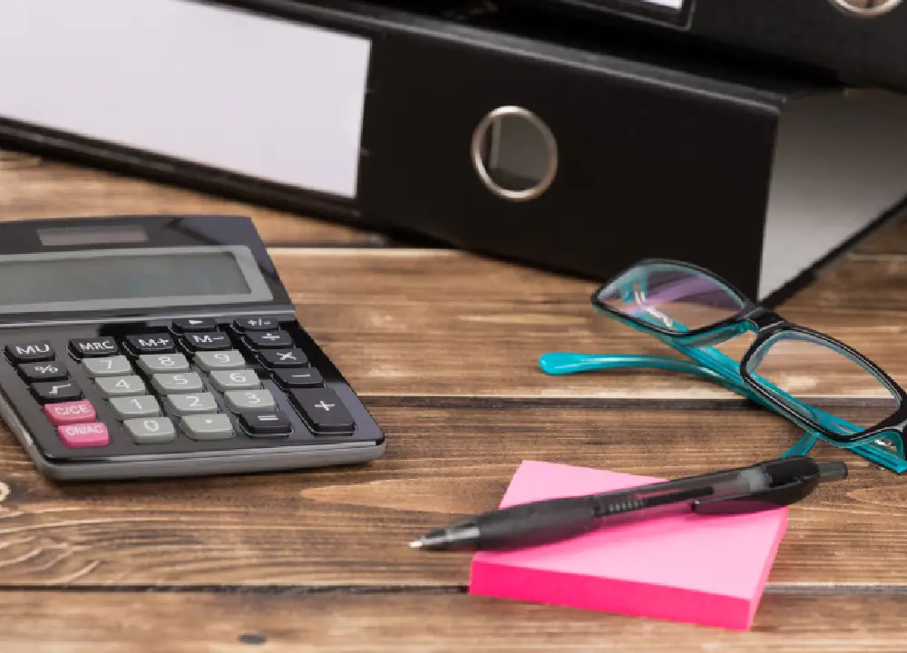 Navigating Mesothelioma Claims: Your Path to Justice 2 Legal documents, folders, and a calculator on a desk related to compensation review