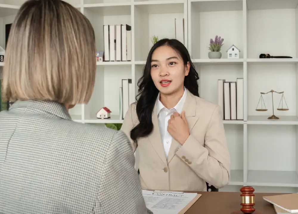 Lawyer consulting with a client in a calm, professional office setting.