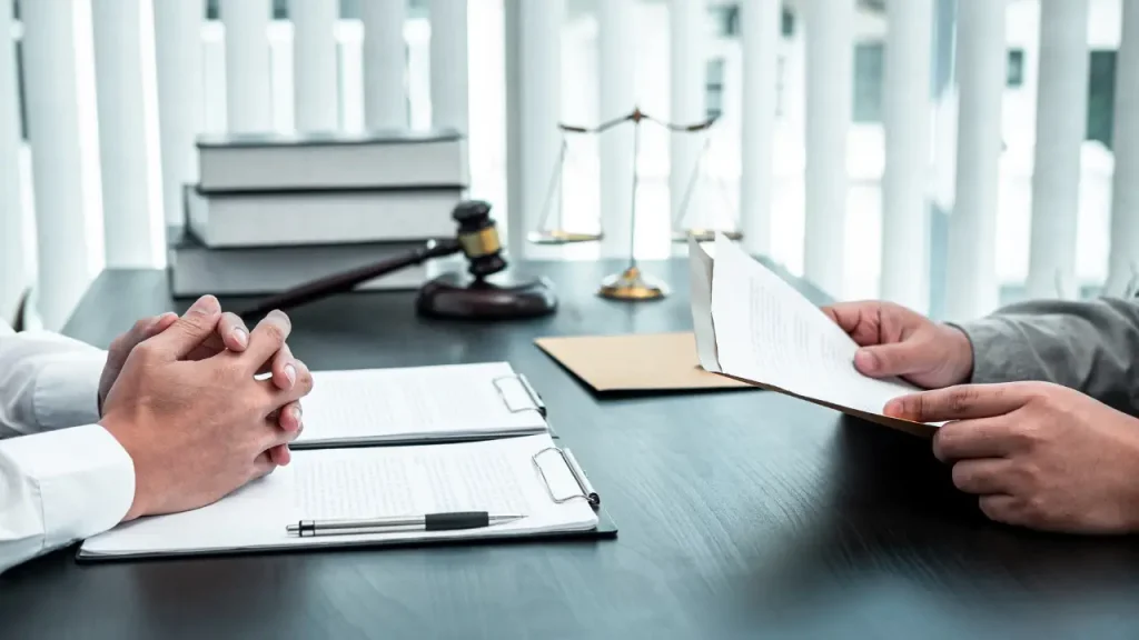 Lawyer reviewing legal documents with a client during a consultation.