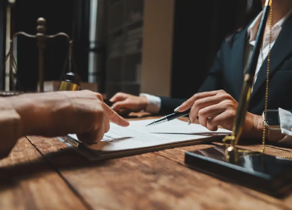 Understanding Mesothelioma Settlements: Your Path to Compensation 1 Lawyer explaining mesothelioma settlement documents to a client during a legal consultation