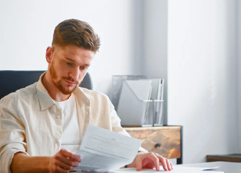 Mesothelioma 101: Symptoms, Causes, and Your Legal Options 1 Person thoughtfully reviewing important information about mesothelioma symptoms and causes.