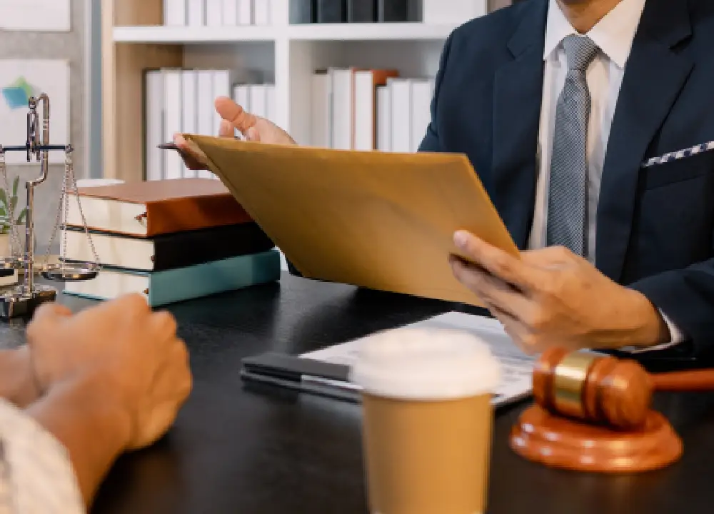 Navigating Asbestos Trust Fund Payments: A Victim’s Guide to Compensation 3 Lawyer speaking with a client during a supportive consultation.