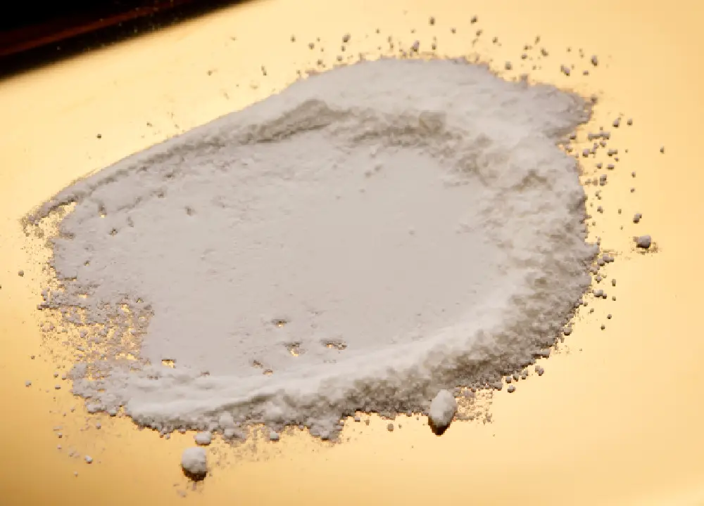 Talc powder spread on a flat surface, shown from a top-down view.