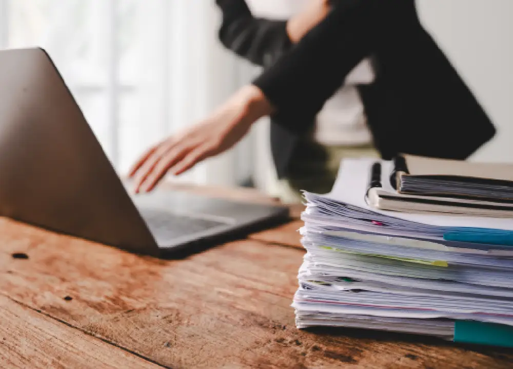 Uploading documents on a laptop as part of an evidence collection process.