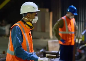 Mesothelioma Claims: The Documentation-First Guide 1 Industrial workers operating machinery inside a metalwork plant, representing potential asbestos exposure in high-risk workplaces