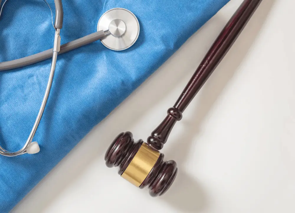 Medical + legal concept image: stethoscope next to legal documents or gavel