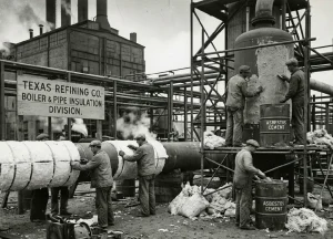 Historical industrial pipefitters installing thermal asbestos insulation at a Texas Gulf Coast oil refinery