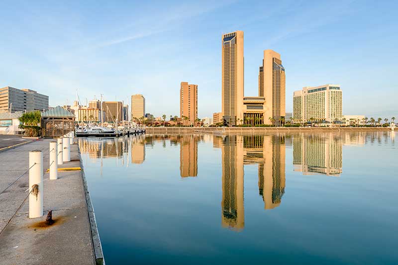Downtown Corpus Christi, Texas skyline reflected in the calm waters of the bayfront marina