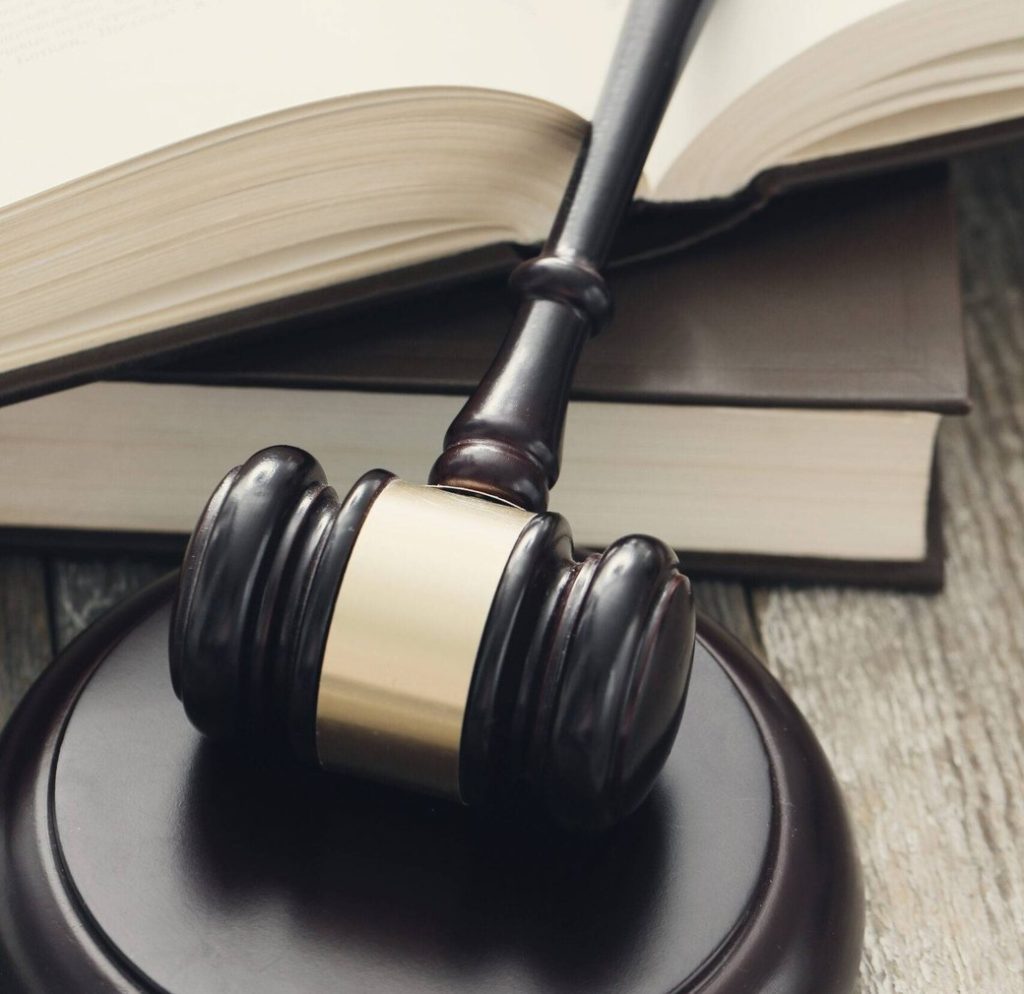 Judge's gavel resting in front of a stack of law books
