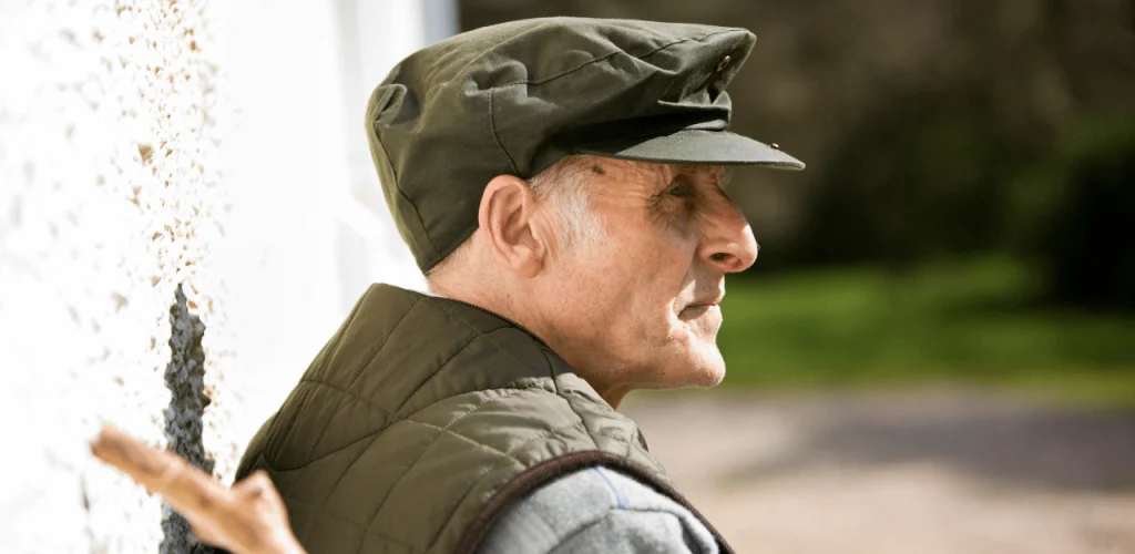 Retired Texas veteran looking out window after lung cancer diagnosis linked to asbestos exposure