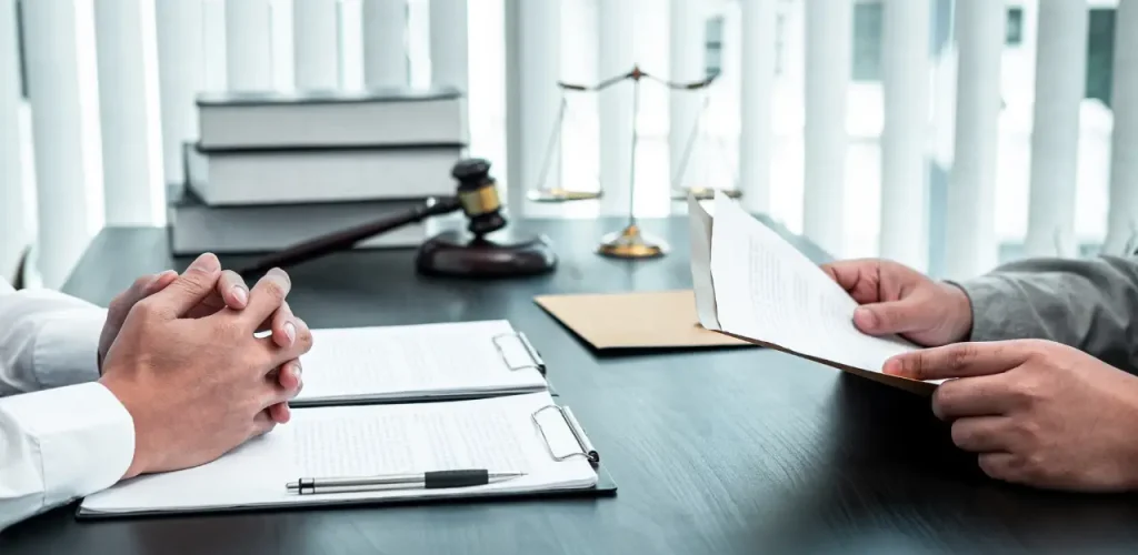Lawyer reviewing legal documents with a client during a consultation.