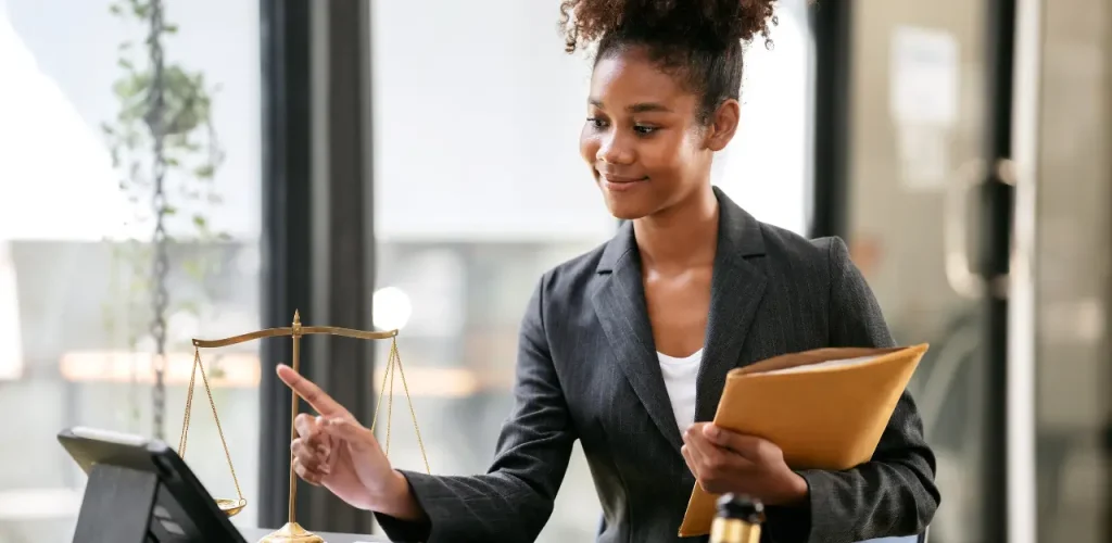 Professional lawyer or claims adjuster reviewing legal documents with a pen in hand.